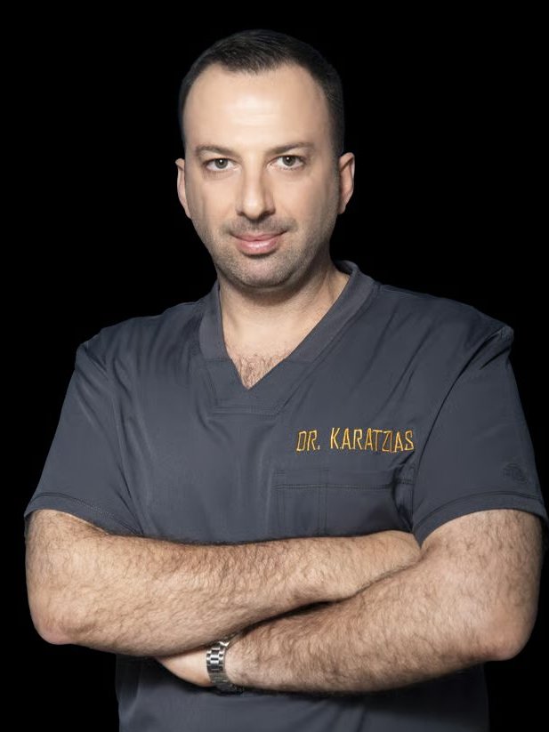 Dr. Angelos Karatzias in surgical scrubs